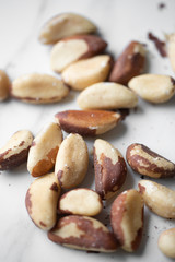 Brazil nuts on white marble background