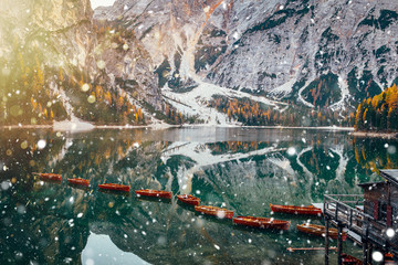 Braies lake in winter time with snowfall.