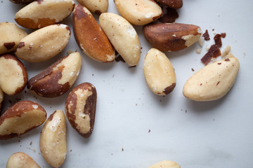 Brazil nuts on white marble background