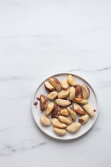 Brazil nuts on white marble background