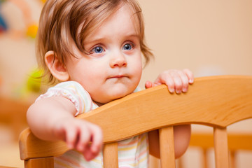 little girl standing in the crib