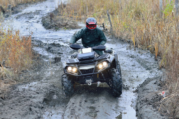 Obraz na płótnie Canvas Cool pictures of active ATV driving in mud and water at Autumn weather