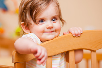 little girl standing in the crib