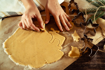 Raw dough on a table with curly cookie cutters.