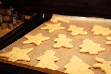Gingerbread figures on waxed paper before baking.