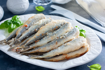 Fried smelt on a white dish, selective focus