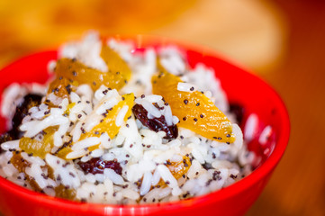 handmade preparation of treats for traditional Orthodox Christmas - rice pudding with fruits, cranberries, honey, nuts, Church candles