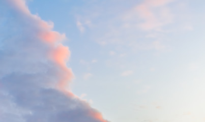 Beautiful puffy clouds at sunset isolated against pastel blue and pink skies