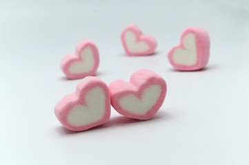 Pink sweet heart shape marshmallow on white background.
