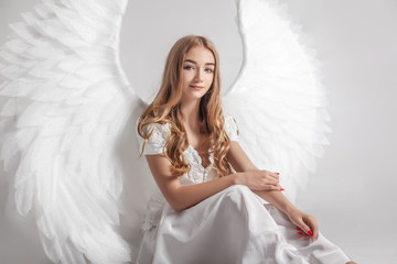 Girl in white dress with angel wings