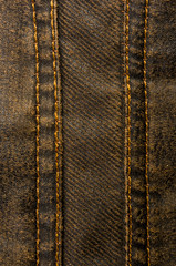 clothing items stonewashed cotton fabric texture with seams, clasps, buttons and rivets, macro