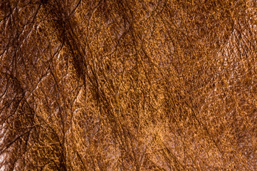 Old vintage genuine soft brown leather texture background, top layer with pores and scratches, macro, close-up