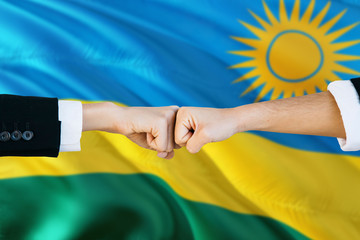 Rwanda agreement concept. Man and woman fist bumping on national flag to show cooperation. Peace and teamwork theme.