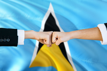 Saint Lucia agreement concept. Man and woman fist bumping on national flag to show cooperation....