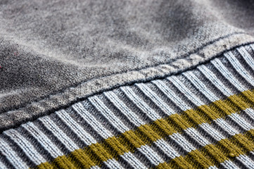 clothing items stonewashed cotton fabric texture with seams, clasps, buttons and rivets, macro