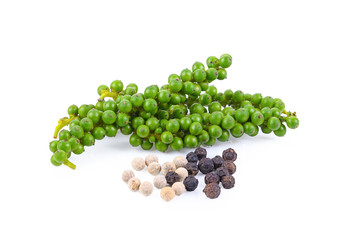 Fresh young green pepper corns and dried black pepper corns on white background