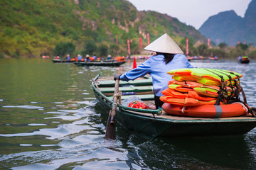 Tourist are traveling by sitting on the rowing boat in the river,  Ninh Binh, Vietnam.