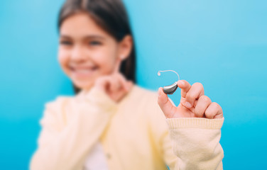advertising hearing aid for children, a mixed race child shows a hearing aid. Children's hearing...