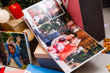 book together near Christmas tree in front of fireplace