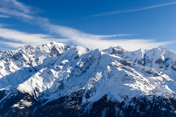 Fototapeta na wymiar Beautiful view from the ski slopes in snow-caped mountains.