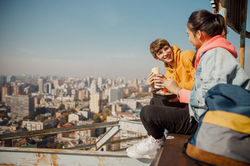 Fototapeta na wymiar Happy boyfriend looking at girlfriend having lunch on roof