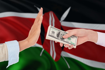 Kenya bribery refusing. Closeup of female hands extending a pile of dollar bills to the male hands...