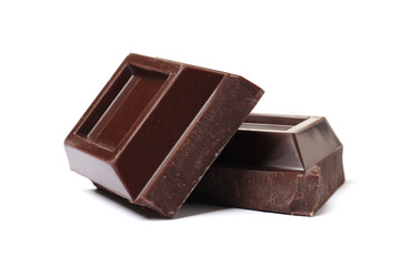 Dark chocolate pieces on white background