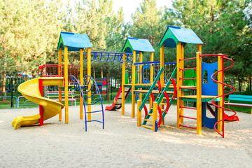 Colorful playground on yard in the park. Colorful children playground,exercise kid,activities in...