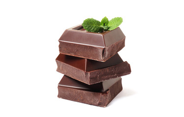 Stack of chocolate pieces with mint on a white background