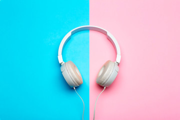Musical headphones on a colored blue and pink background. Aesthetics retro 80s and minimal concept