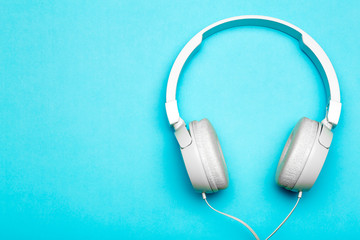 Musical headphones on a colored blue background. Aesthetics retro 80s and minimal concept
