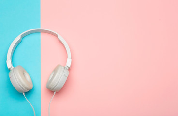 Musical headphones on a colored blue and pink background. Aesthetics retro 80s and minimal concept