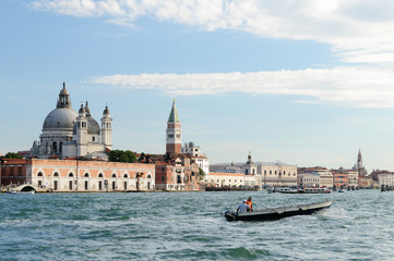 Venice promenade with Church of Santa Maria della Salute in summer sunny day with a gondola sights of Italy in the Adriatic