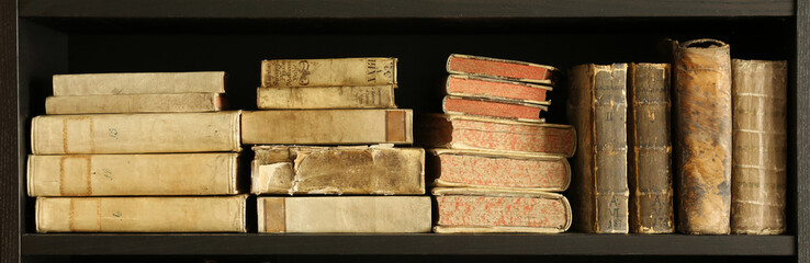 old books on wooden shelf.