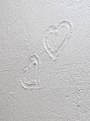 A painted heart on a wet white wall. Wall painting textured paint.