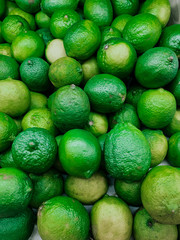 lots of ripe green sour limes for eating as a background