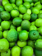 lots of ripe green sour limes for eating as a background