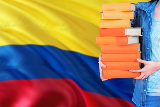 Colombia National Education Concept. Close Up Of Female Student Holding Colorful Books With Country Flag Background.