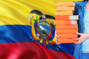 Ecuador national education concept. Close up of female student holding colorful books with country...