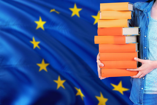 European Union National Education Concept. Close Up Of Female Student Holding Colorful Books With Country Flag Background.