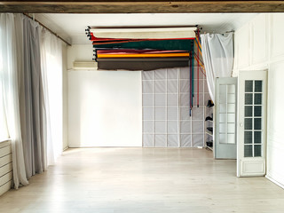 white photo studio with backgrounds accessories of a professional photographer