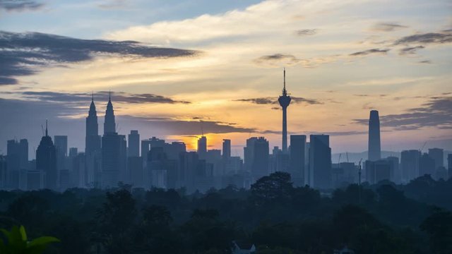 4k time lapse of clear sunrise from Kuala Lumpur city skyline. 