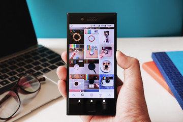 CHIANG MAI, THAILAND - March 25, 2018: A man holds Sony xperia xzs with Instagram application on the screen. Instagram is a photo-sharing app for smartphones.