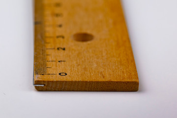 A wooden ruler on a white table
