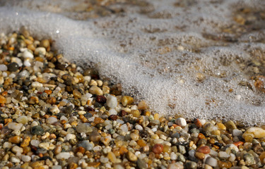 close up of a pebble beach when a wave came