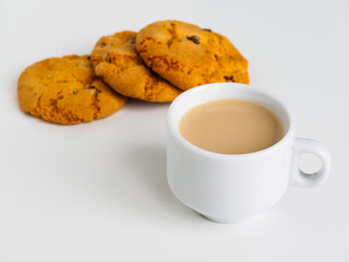 Cup of coffee with milk. Raisin cookies