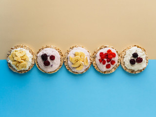 A sweet Breakfast of Crispbread, cottage cheese and fruit on a colored background. Copy space