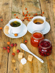 Two cups of tea and jam on a wooden table. Tea in a cozy atmosphere