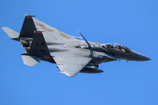 LAKENHEATH, UK - JUL 12, 2018: US Air Force F-15E Strike Eagle bomber jet airplane in flight over RAF Lakenheath airbase.