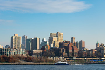 Fototapeta na wymiar Brooklyn Heights Skyline with the East River in New York City with a Ferry Boat